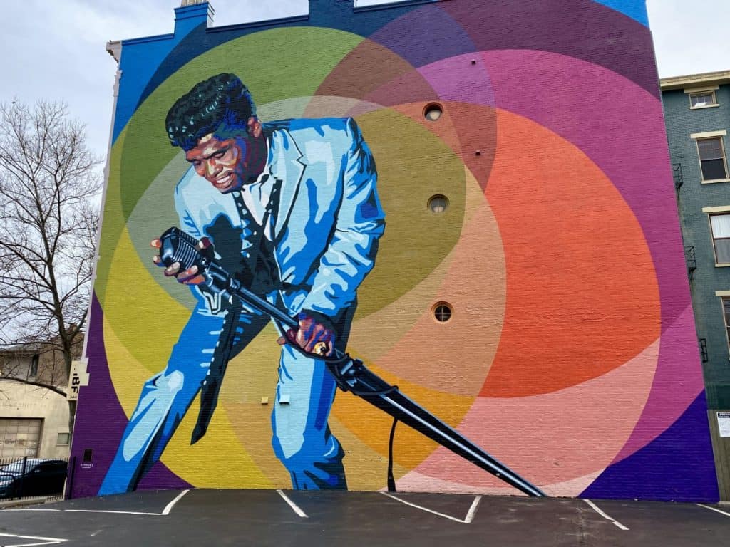 A mural of a musician performing.